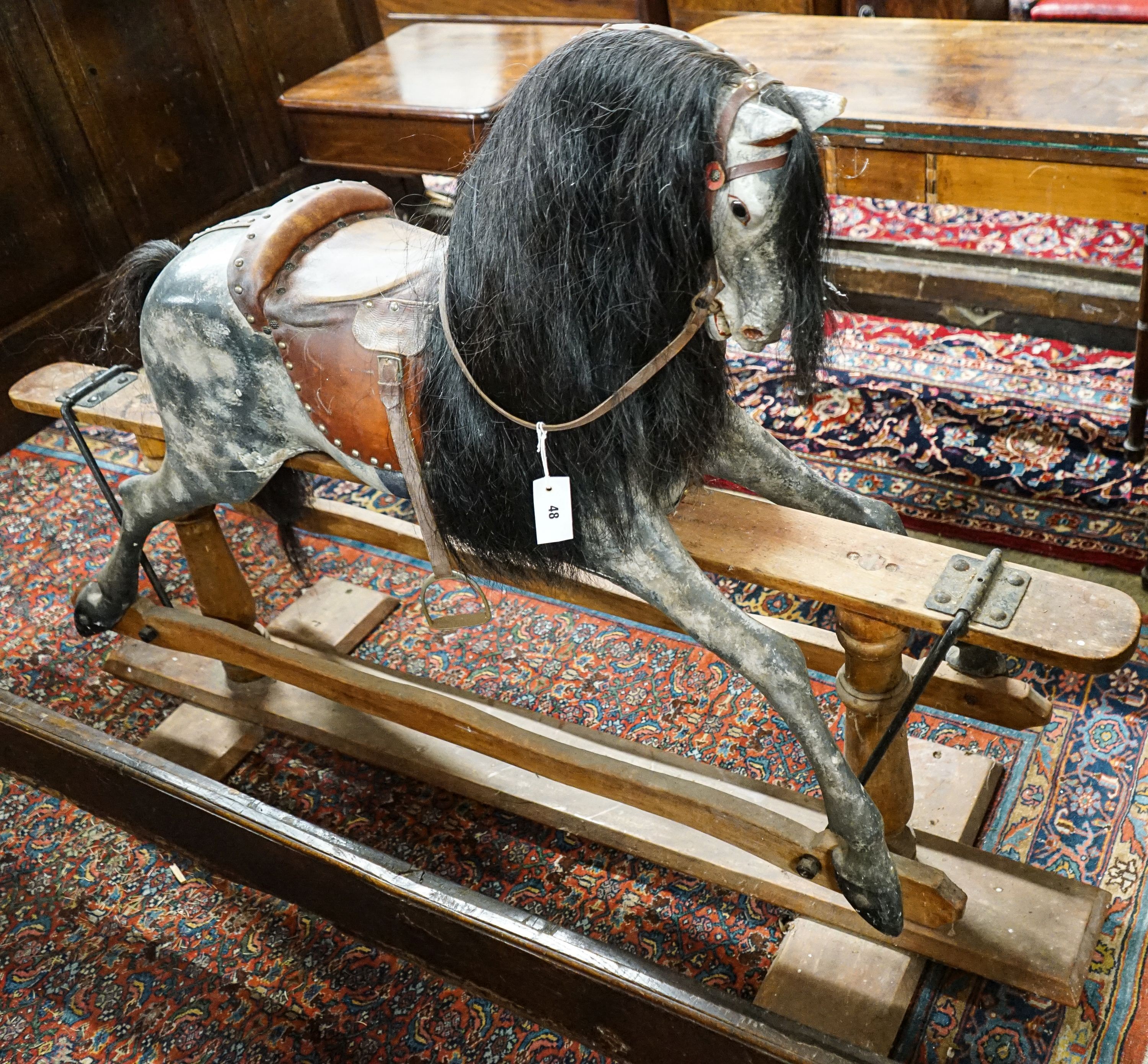 A large Edwardian Ayres type rocking horse on a turned safety frame, length 160cm, height 110cm